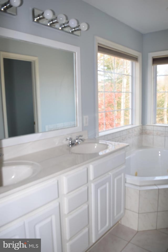 531 Washout Ln, Winchester, VA 22603 - bathroom with a tub with jets, tile patterned flooring, double vanity, and a sink