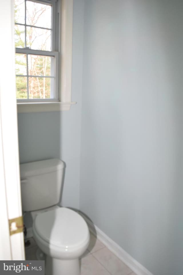 bathroom featuring toilet and tile patterned flooring