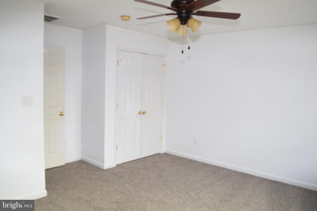 unfurnished bedroom with light colored carpet, ceiling fan, and a closet