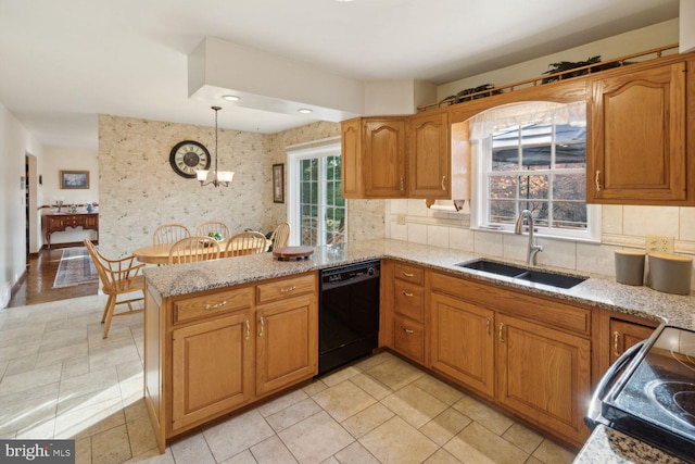 kitchen with dishwasher, backsplash, sink, decorative light fixtures, and kitchen peninsula