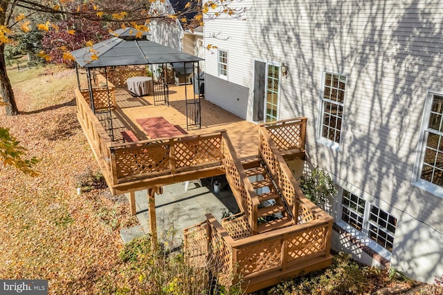 wooden terrace featuring a gazebo