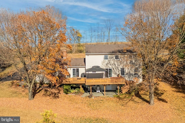 rear view of house with a deck and a patio area