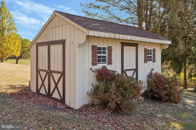 view of outdoor structure featuring a lawn