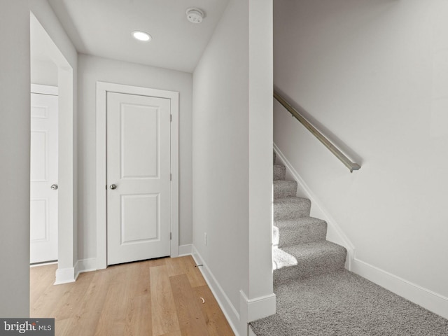 staircase with hardwood / wood-style floors