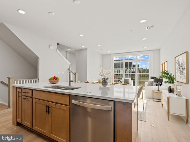 kitchen with dishwasher, a center island with sink, light hardwood / wood-style flooring, and sink