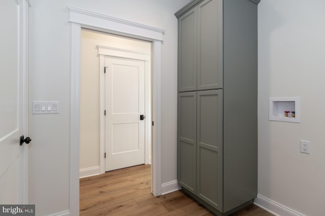 washroom featuring light hardwood / wood-style floors, cabinets, and washer hookup