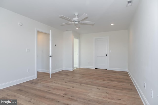 spare room featuring ceiling fan and light wood-type flooring