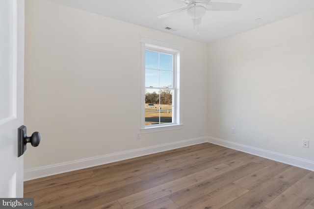 spare room featuring ceiling fan and light hardwood / wood-style flooring