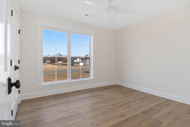 spare room with ceiling fan and light hardwood / wood-style floors