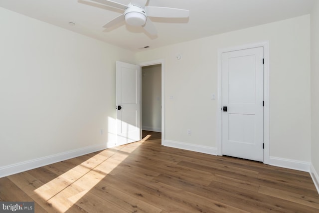 unfurnished room with hardwood / wood-style floors and ceiling fan