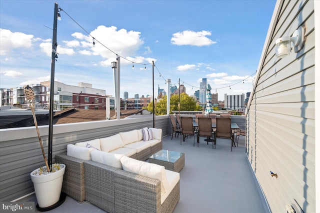 view of patio featuring a balcony and an outdoor living space