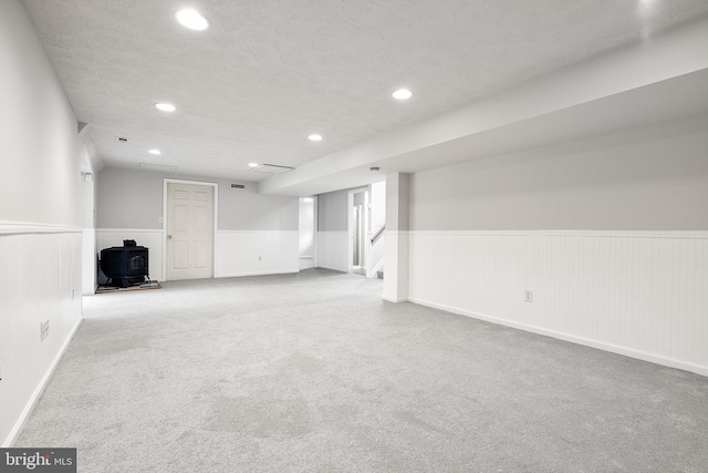 basement with light carpet and a textured ceiling