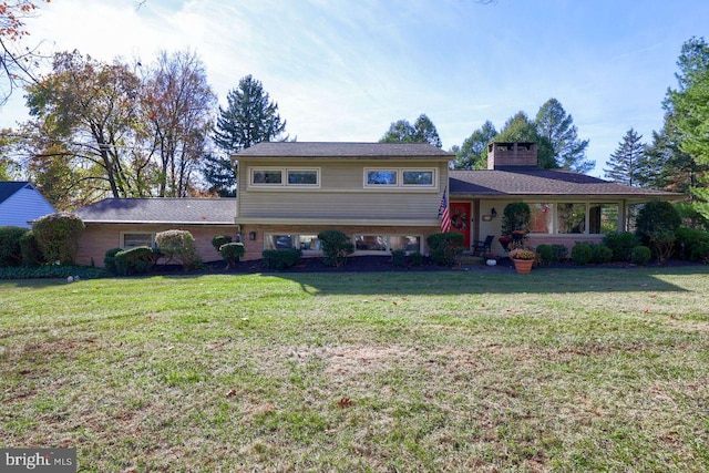 split level home featuring a front lawn