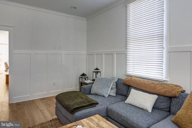 sitting room with ornamental molding and hardwood / wood-style floors