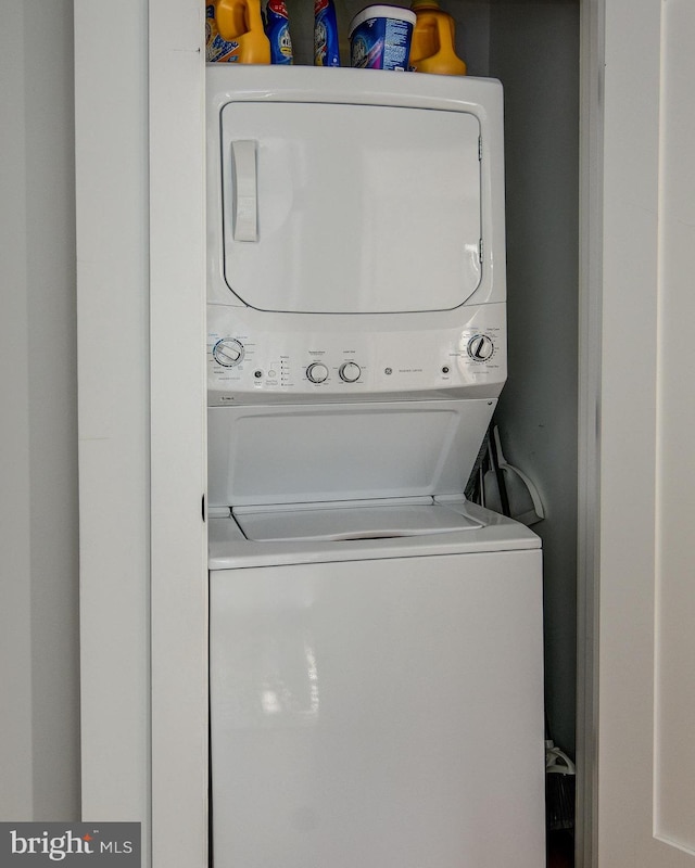 laundry room with stacked washing maching and dryer