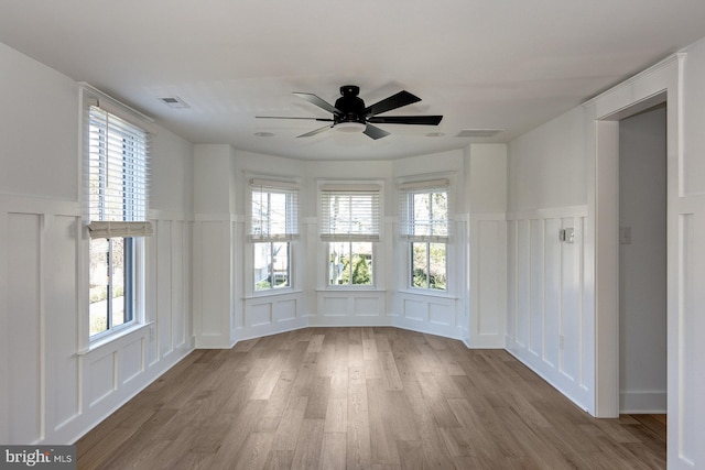 unfurnished room featuring hardwood / wood-style flooring and ceiling fan