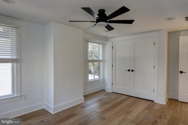 unfurnished bedroom featuring ceiling fan, a closet, and light hardwood / wood-style flooring