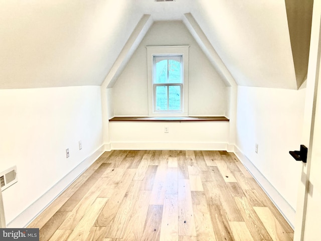 bonus room featuring vaulted ceiling and light hardwood / wood-style flooring