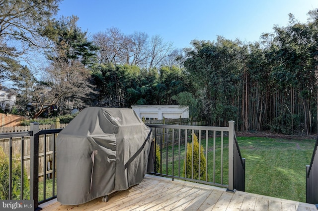 deck with a yard, a storage shed, and grilling area