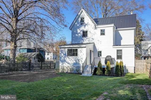 rear view of house with a lawn