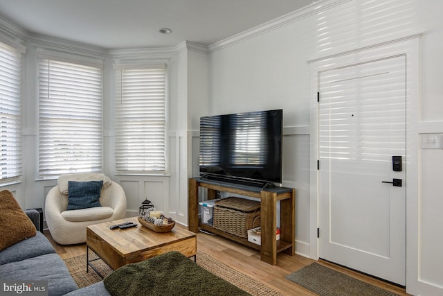 living room featuring light hardwood / wood-style flooring and ornamental molding