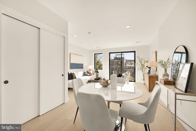 dining space with light wood-type flooring