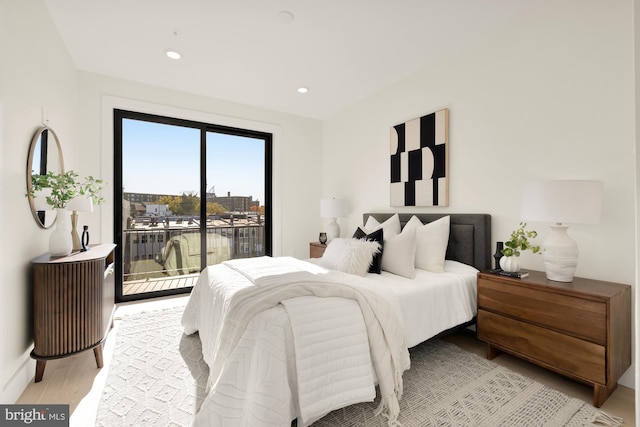 bedroom featuring access to exterior and light hardwood / wood-style floors