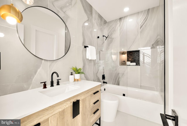 full bathroom with tile patterned flooring, vanity, toilet, and bath / shower combo with glass door