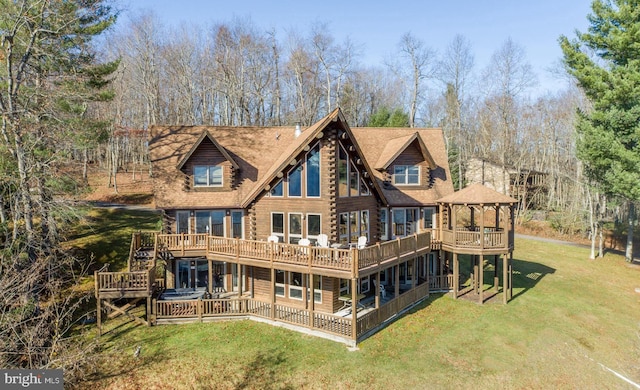 back of house featuring a wooden deck, a lawn, and a gazebo