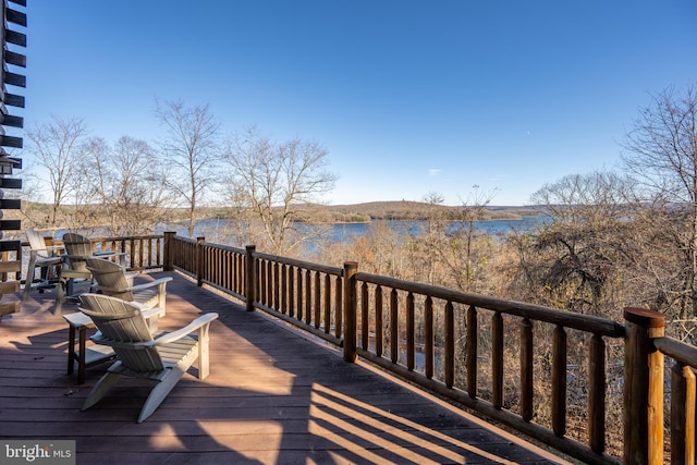 wooden terrace featuring a water view