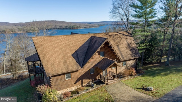 birds eye view of property with a water and mountain view