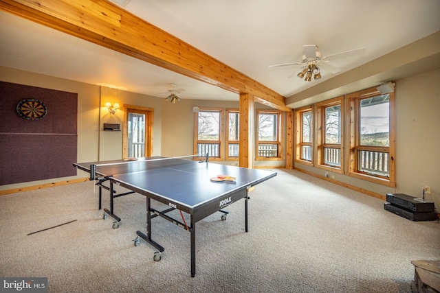 recreation room featuring beamed ceiling, carpet, and ceiling fan