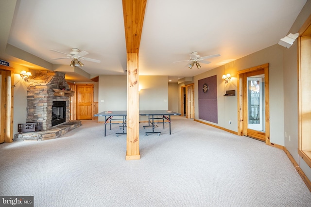 recreation room featuring carpet flooring, a fireplace, and ceiling fan