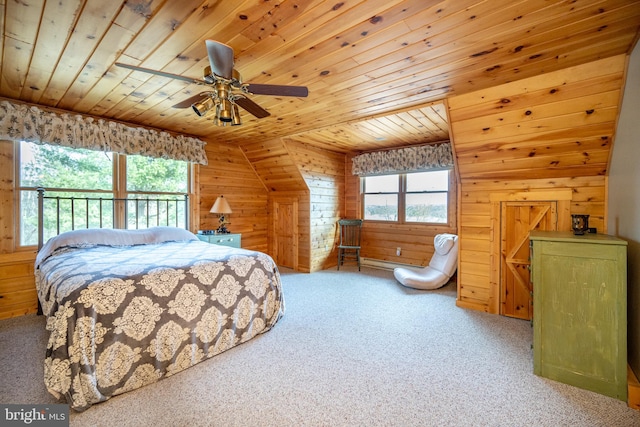 carpeted bedroom featuring wooden walls, vaulted ceiling, wooden ceiling, and ceiling fan