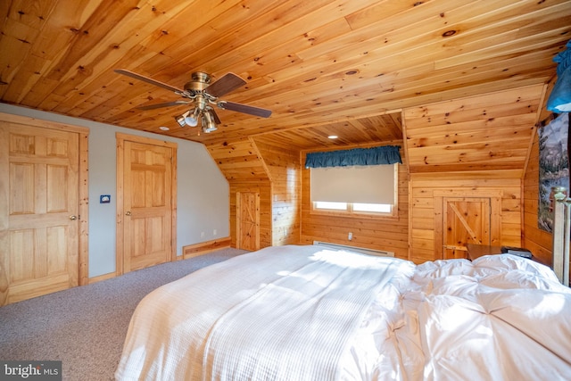 unfurnished bedroom with carpet flooring, wood walls, wood ceiling, lofted ceiling, and ceiling fan