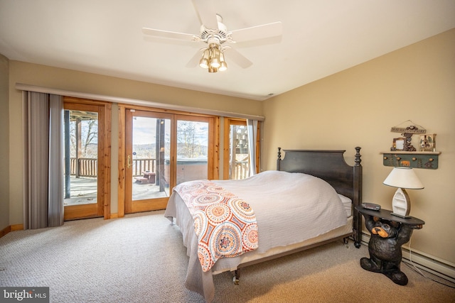 carpeted bedroom featuring ceiling fan, multiple windows, a baseboard radiator, and access to outside