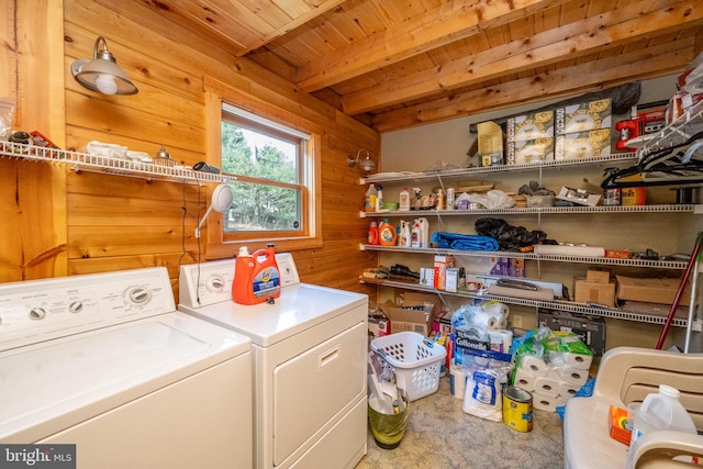 washroom featuring separate washer and dryer, wooden walls, and wooden ceiling