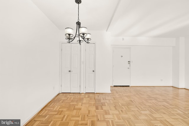 interior space featuring light parquet floors and a notable chandelier