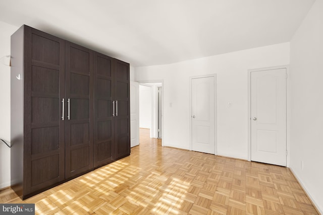 unfurnished bedroom featuring light parquet floors