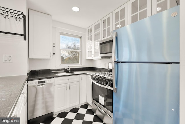 kitchen featuring sink, white cabinetry, and stainless steel appliances