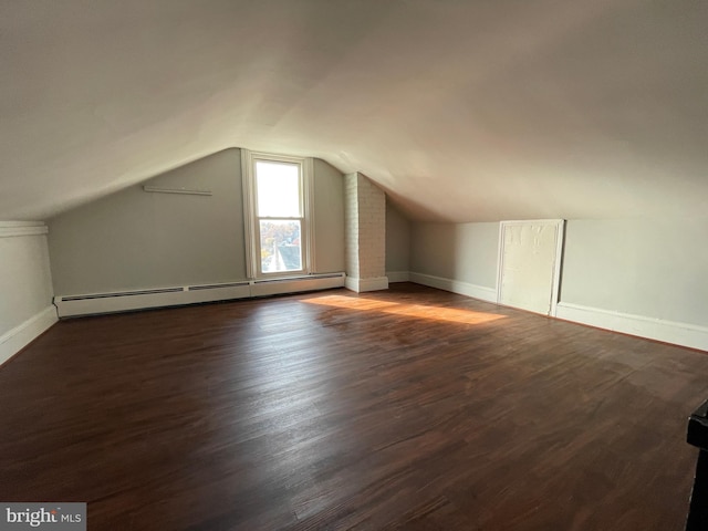 bonus room featuring dark hardwood / wood-style floors, a baseboard radiator, and lofted ceiling