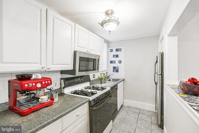 kitchen with stainless steel appliances, white cabinetry, light tile patterned floors, and decorative backsplash