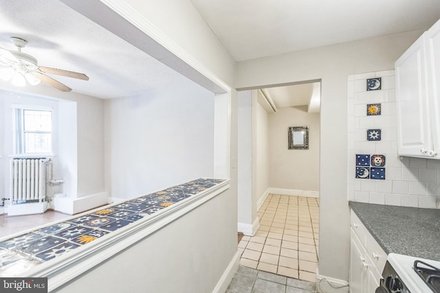 interior space with radiator heating unit and light tile patterned floors