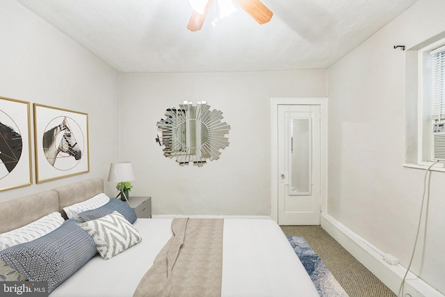 carpeted bedroom with ceiling fan and a textured ceiling