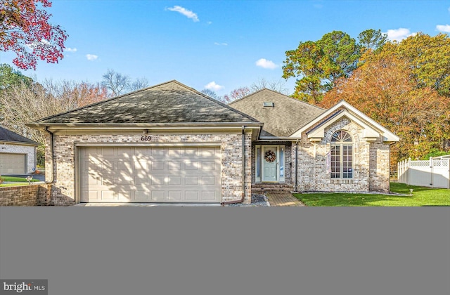 view of front facade with a front lawn and a garage