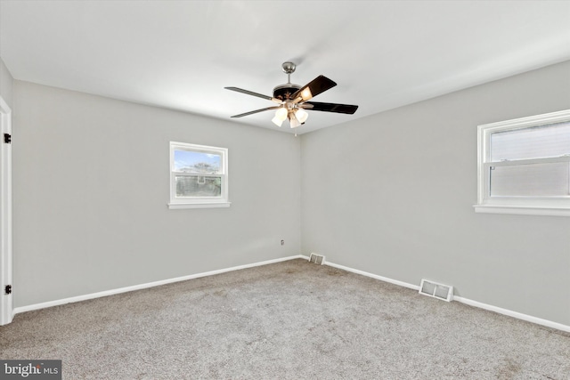 carpeted spare room with ceiling fan