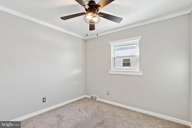 carpeted empty room featuring ceiling fan and a textured ceiling