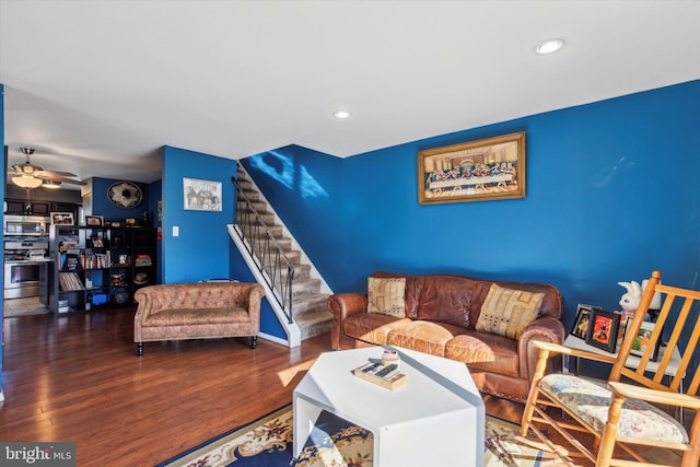 living room featuring hardwood / wood-style flooring and ceiling fan