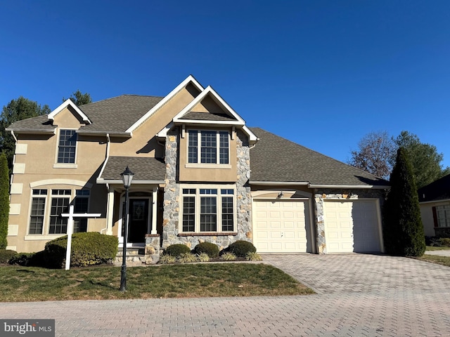 view of front facade featuring a garage and a front lawn