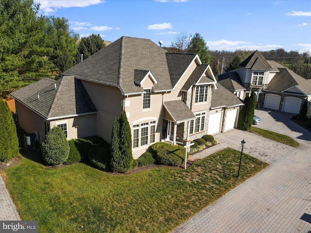 15 Laurel Hill Ct, Gettysburg, PA 17325 - traditional home with stucco siding, decorative driveway, a front yard, and a shingled roof